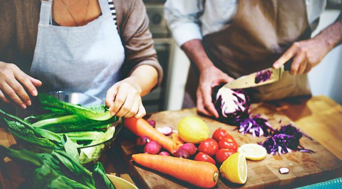 man and woman preparing food
