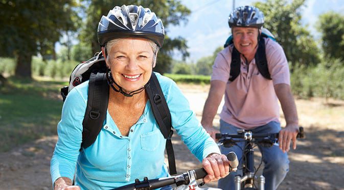 elderly couple riding bikes